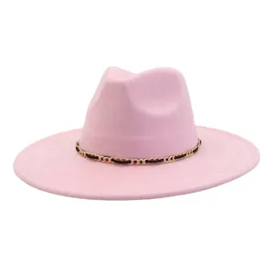 Pink fedora hat detail featuring a stylish gold chain and black band design for fashion wear.