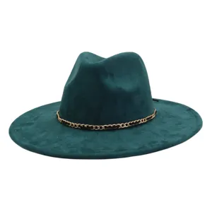 Close-up detail of the dark green suede fedora hat, highlighting the metallic chain decoration.