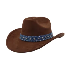 Close-up detail of the brown suede western cowboy hat featuring blue denim band and studs.