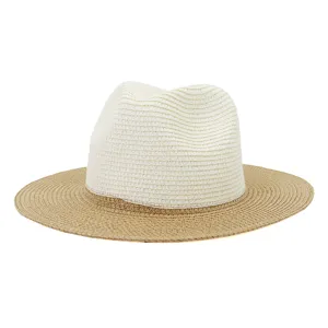 Detail view of stylish two-tone straw fedora hat for summer outdoor travel and sun protection.