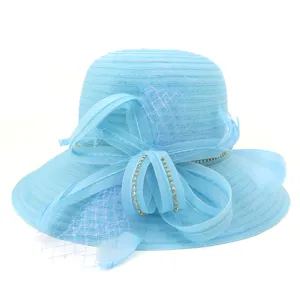 Light blue organza sun hat detail, wide brim design with bow, mesh, feathers and rhinestones.