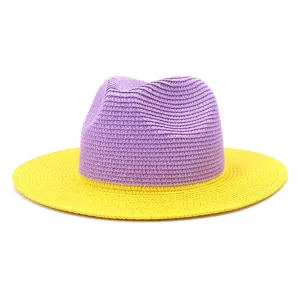 Detail of stylish color-blocked straw fedora hat featuring purple crown and vibrant yellow brim.