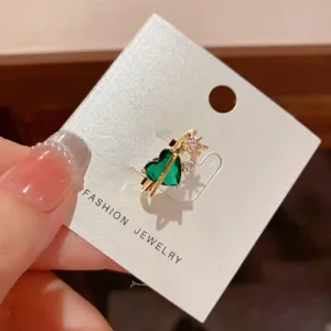 Exquisite green heart zircon open ring with star detail, fashionable minimalist jewelry design.