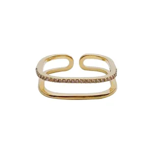 Minimalist gold open ring featuring sparkling pave zircon stones, modern geometric design.