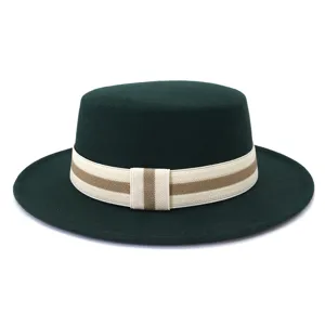 Detailed view of dark green woolen flat-top hat featuring striped elastic band decor.