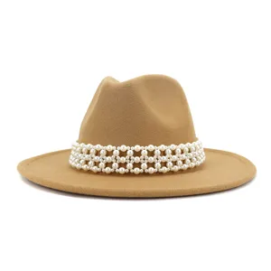 Detail view of a camel wool felt fedora hat featuring an elegant wide woven pearl band trim.