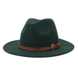 Close-up detail of dark green woolen felt fedora hat with brown leather strap and metal buckle.
