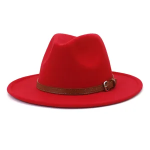 Detail view of red woolen fedora hat with brown leather belt and metal buckle, British style.