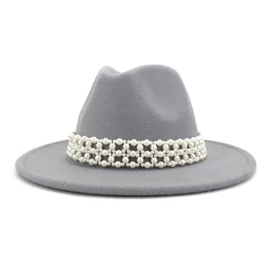 Close-up detail of grey wool fedora hat with elegant multi-layer pearl woven band trim.