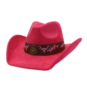 Pink suede cowboy hat detail, vintage western style with bull embroidery and metal badge.