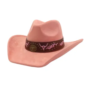 Pink suede western cowboy hat detail, featuring brown band, metal studs, and bull skull embroidery.