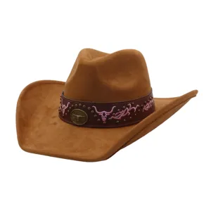 Close-up detail of brown soft suede cowboy hat with leather band, studs and pink embroidery.