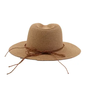 Vue détaillée de la texture du chapeau de paille avec un joli cordon décoratif marron.