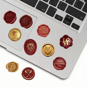 Detailed view of vintage wax seal stickers featuring romantic love and heart designs on a laptop.