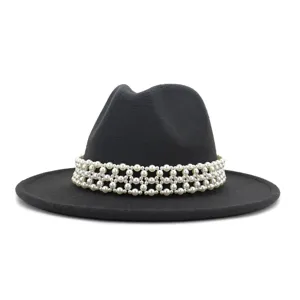Detail view of the black wool fedora hat adorned with an elegant multi-row faux pearl band.