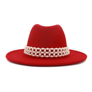 Red wool felt fedora hat with elegant pearl beaded band, stylish wide brim design.