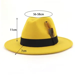 Yellow wool fedora hat detail, wide brim jazz cap with black band and feather decoration.