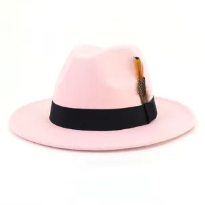 Pink wool fedora hat for women men, wide brim jazz cap with black band and feather decor.