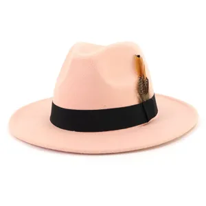 Close-up detail of the elegant pink felt fedora hat with black ribbon and chic feather.