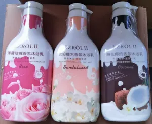 Detailed view of three scented shower gel bottles: rose, sandalwood, and coconut variants.