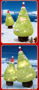 Detailed view of the cute plush Christmas tree toy with lights and Santa hat in a snowy scene.