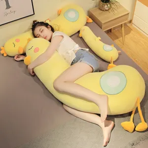 Cute yellow duck long body pillow, soft plush hug toy for sleeping and cuddling on bed.