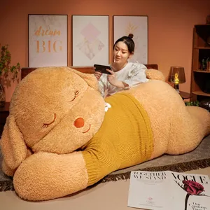 Giant sleeping dog plush toy with cute yellow sweater, soft stuffed animal pillow for bedroom.