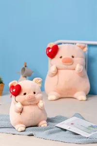 Close-up detail of cute pink plush pig toy holding a red heart balloon in cozy room.