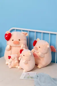Cute angel pig plush toy detail showing soft pink fabric, heart balloon, and cute wings.