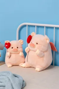 Detailed view of cute angel pig plush toys with heart balloons, soft stuffed dolls.