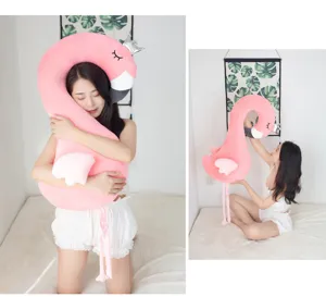 Close-up detail shot of a cute pink flamingo plush toy pillow with silver crown and soft stuffing.