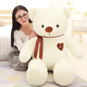 Large plush teddy bear stuffed animal with brown ribbon bow and love heart embroidery toy.