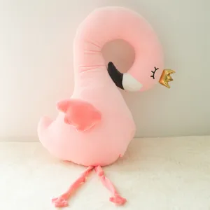 Soft pink flamingo plush pillow detail, cute stuffed animal toy with golden crown.