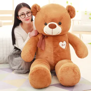 Large brown teddy bear plush toy with ribbon and heart patch, sweet huggable gift for you.