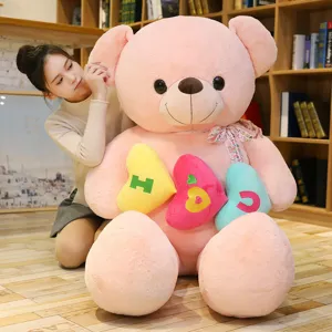 Gigante orsacchiotto di peluche rosa con cuscini a cuore, regalo perfetto per San Valentino.