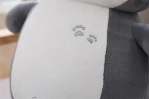Cute husky plush toy detail shot showing soft fabric and cute paw print embroidery.