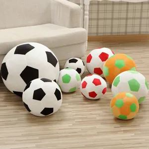 Detailed view of colorful plush soccer ball pillows arranged neatly on wooden floor indoors.
