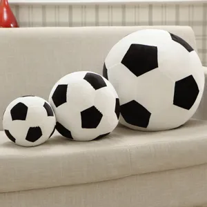Detailed view of three soft plush football pillows in various sizes arranged neatly on a cozy sofa.