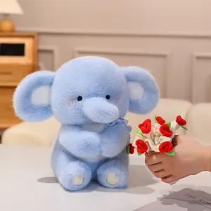 Mignon éléphant en peluche bleu tenant un bouquet de roses, cadeau de Saint-Valentin idéal.