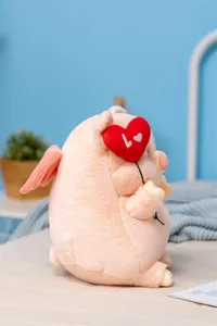 Cute angel pig plush toy detail view, soft pink stuffed animal with heart balloon and wings.