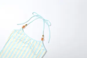 Close-up detail of a chic women halter neck striped sleeveless top with elegant beaded straps.