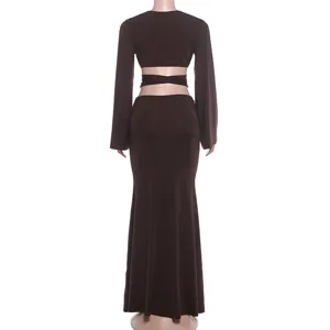Dark brown two-piece set featuring a cutout long-sleeve crop top and a slim maxi skirt detail.