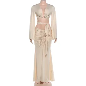 Detail view of the elegant two-piece cutout crop top and ruched maxi skirt set, beige.