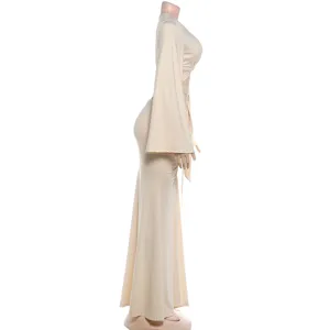Side profile view showing the elegant bell flare sleeve detail and slim long skirt fit.