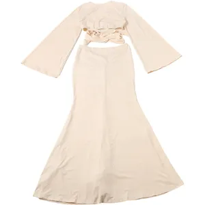 Detail shot of the solid color long sleeve crop top and slim fit maxi skirt set, beige.