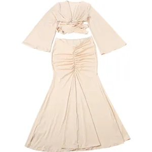 Women two-piece set, solid color V-neck bell sleeve crop top and ruched mermaid skirt.
