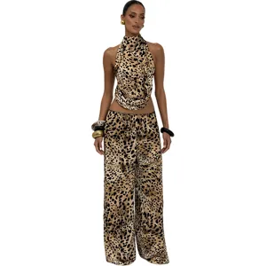 Leopard print halter top and wide-leg trousers outfit detail showing trendy aesthetic.