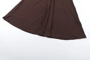 Detailed view of the elegant brown pleated skirt fabric, showing soft drape and texture.