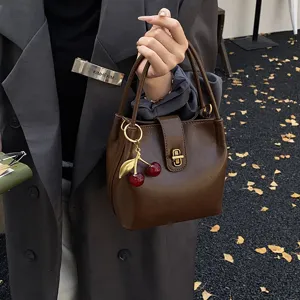 Vintage brown bucket handbag for women, autumn winter chic shoulder bag with cherry charm.