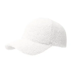 White fluffy fleece baseball cap detail view, soft lamb wool winter hat texture close-up.